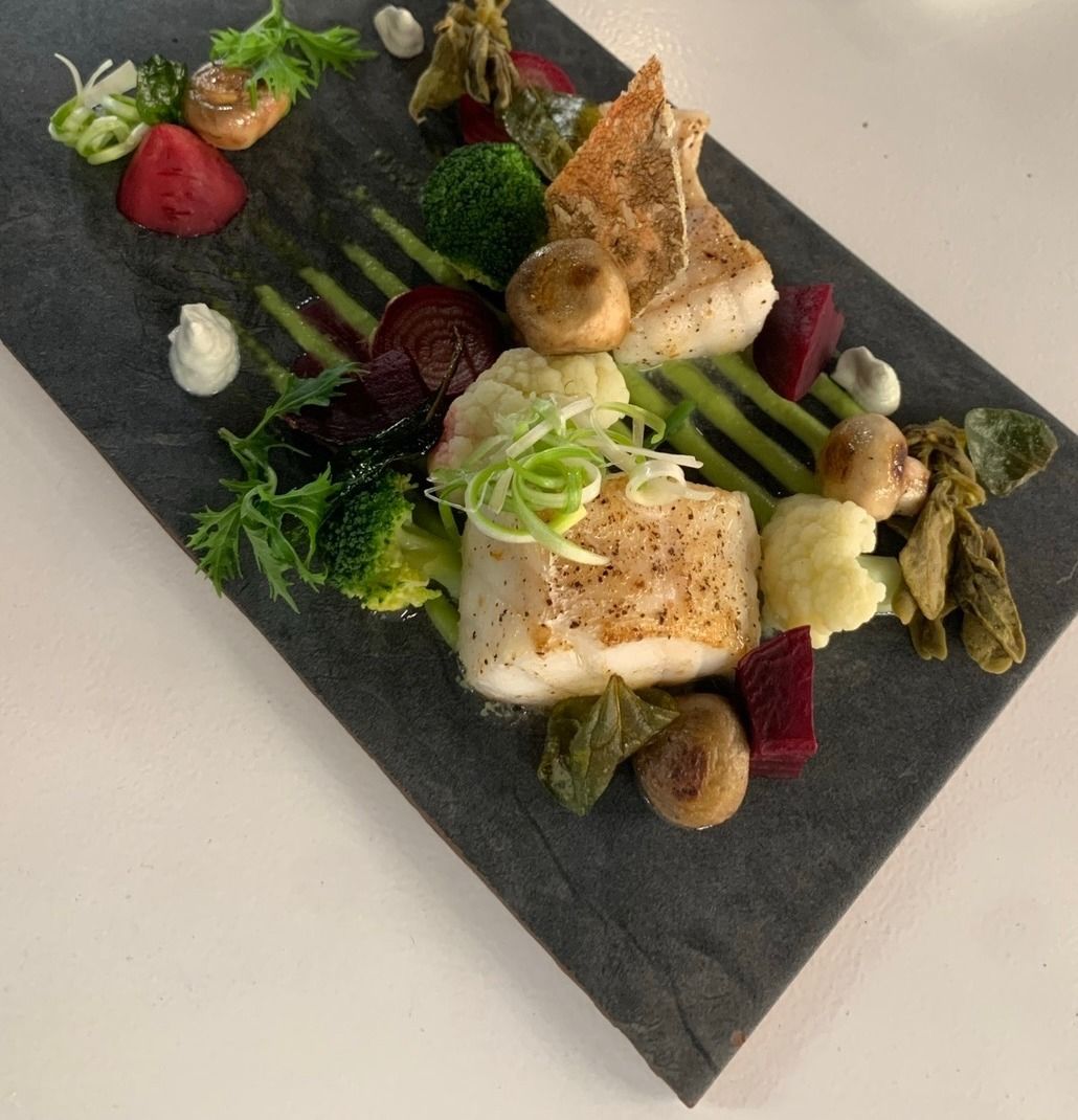Pan-roasted fish on slate with beetroot, cauliflower and pea purée